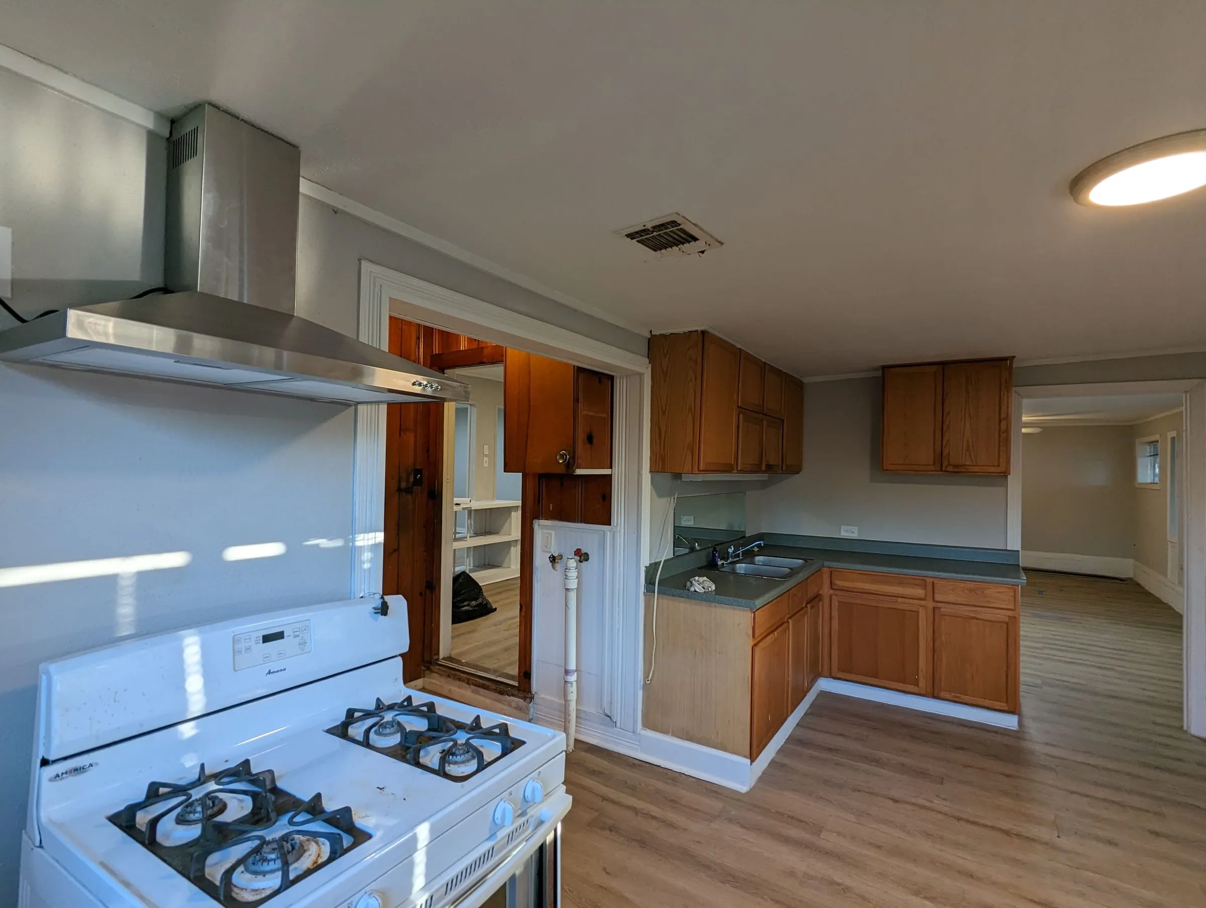 Kitchen with a stainless hood and new flooring