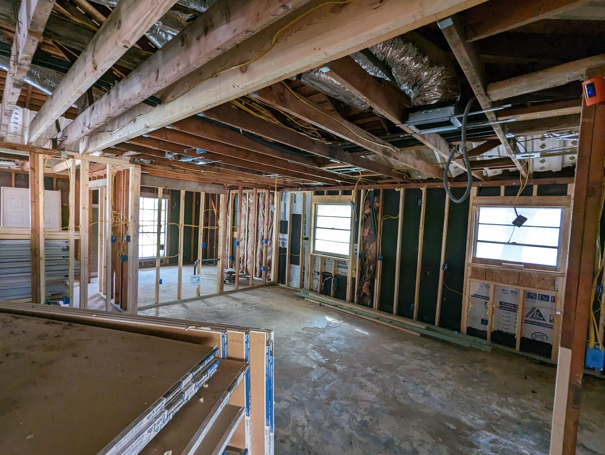 Large interior opened to framing, joists, and ductwork