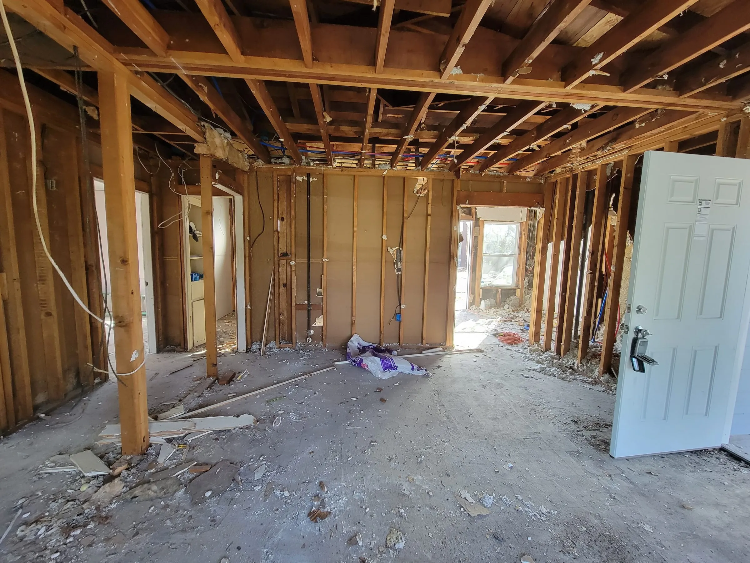 House interior opened to the studs and ceiling joists