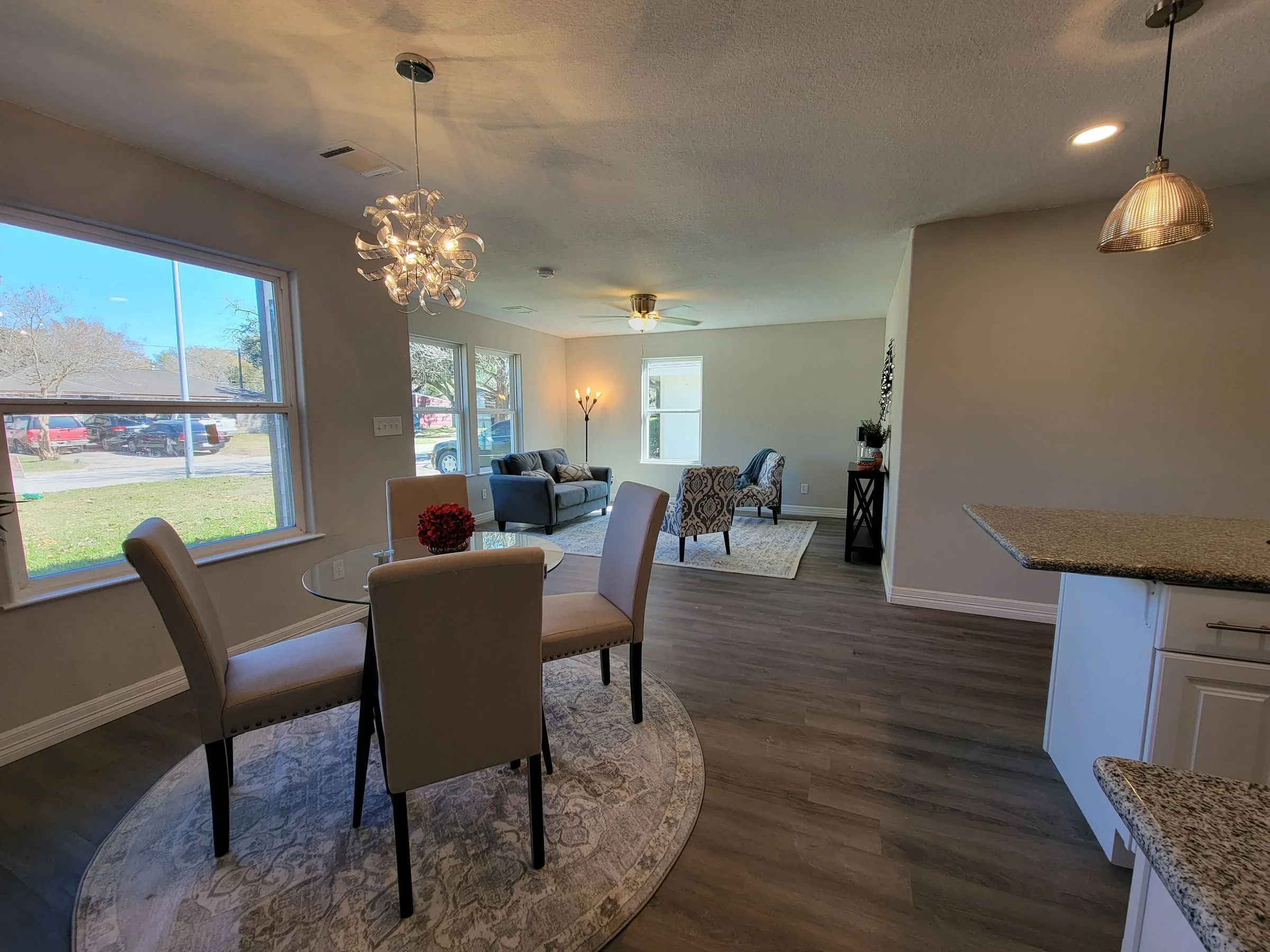 Bright dining area with a chandelier and new plank floors