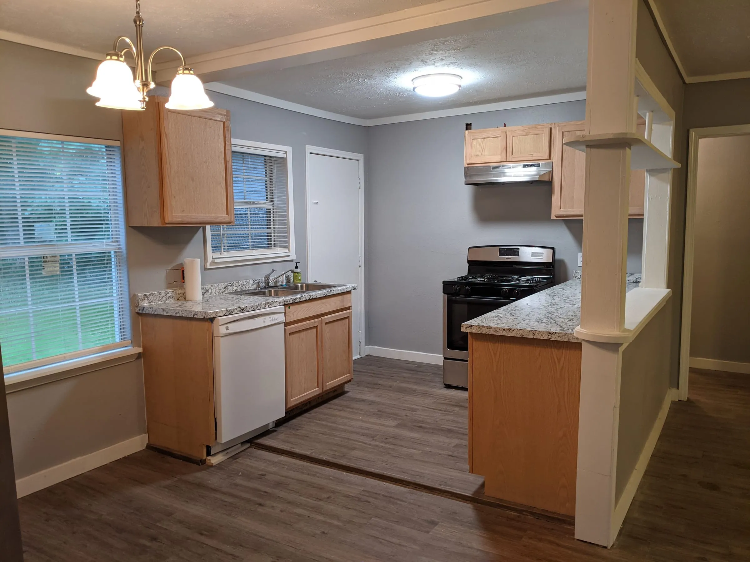 Updated kitchen with granite counters and a stainless range